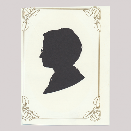 
        Front of silhouette, with man in frame looking left, wearing glasses.